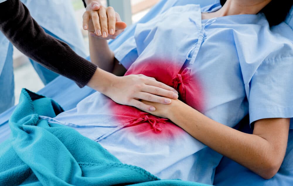 Doctor,Is,Holding,A,Handle,On,The,Patient's,Stomach.,She